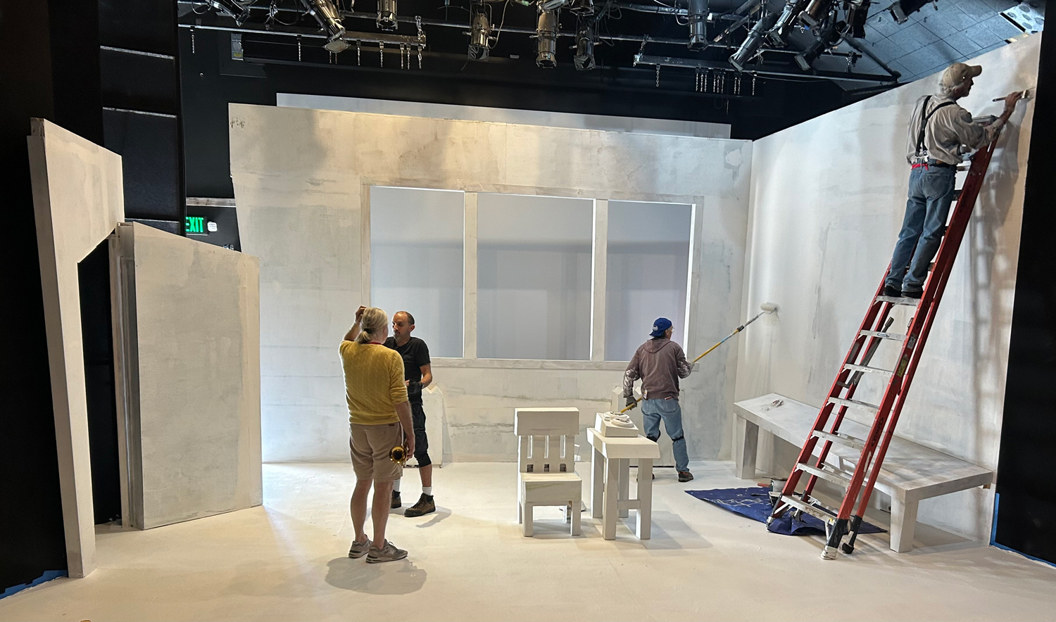 Stage hands setting up Tom Christopher's set design